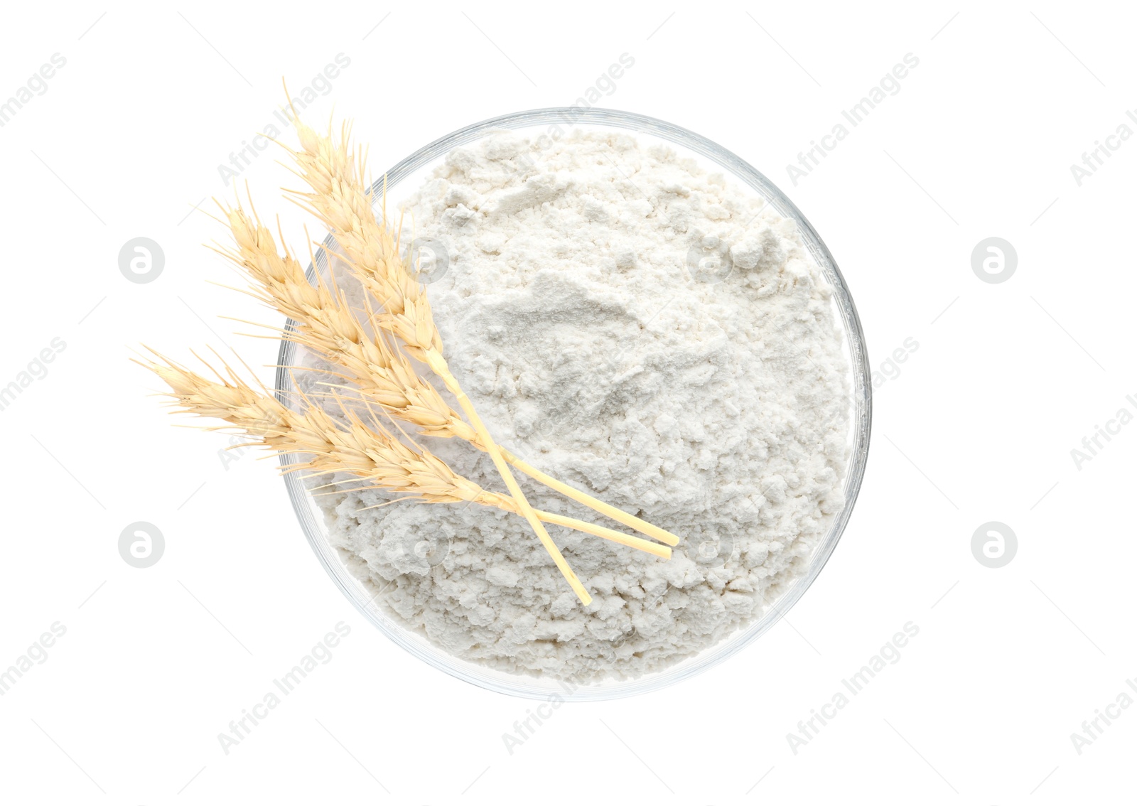 Image of Wheat flour in bowl and spikelets on white background, top view