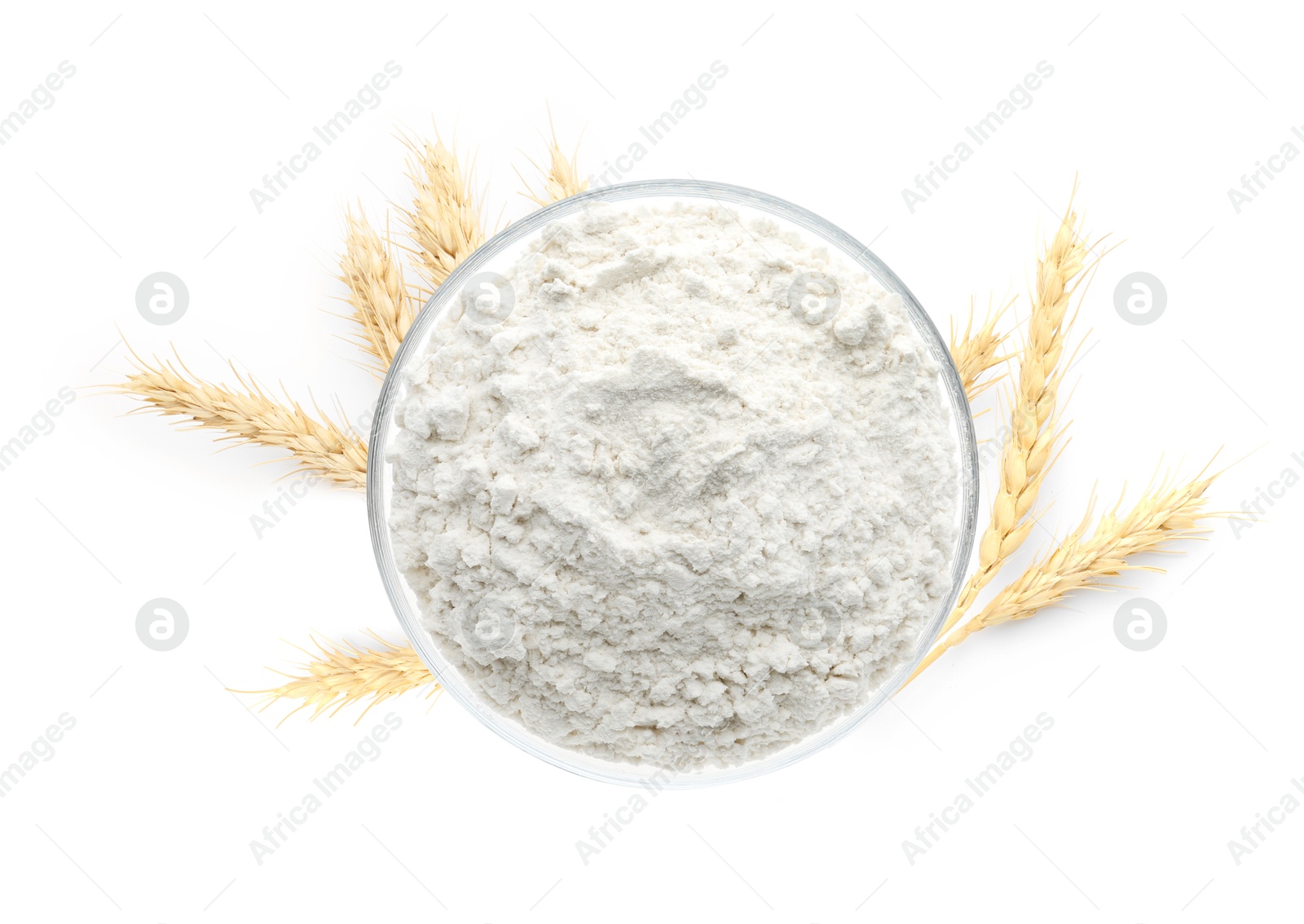 Image of Wheat flour in bowl and spikelets on white background, top view