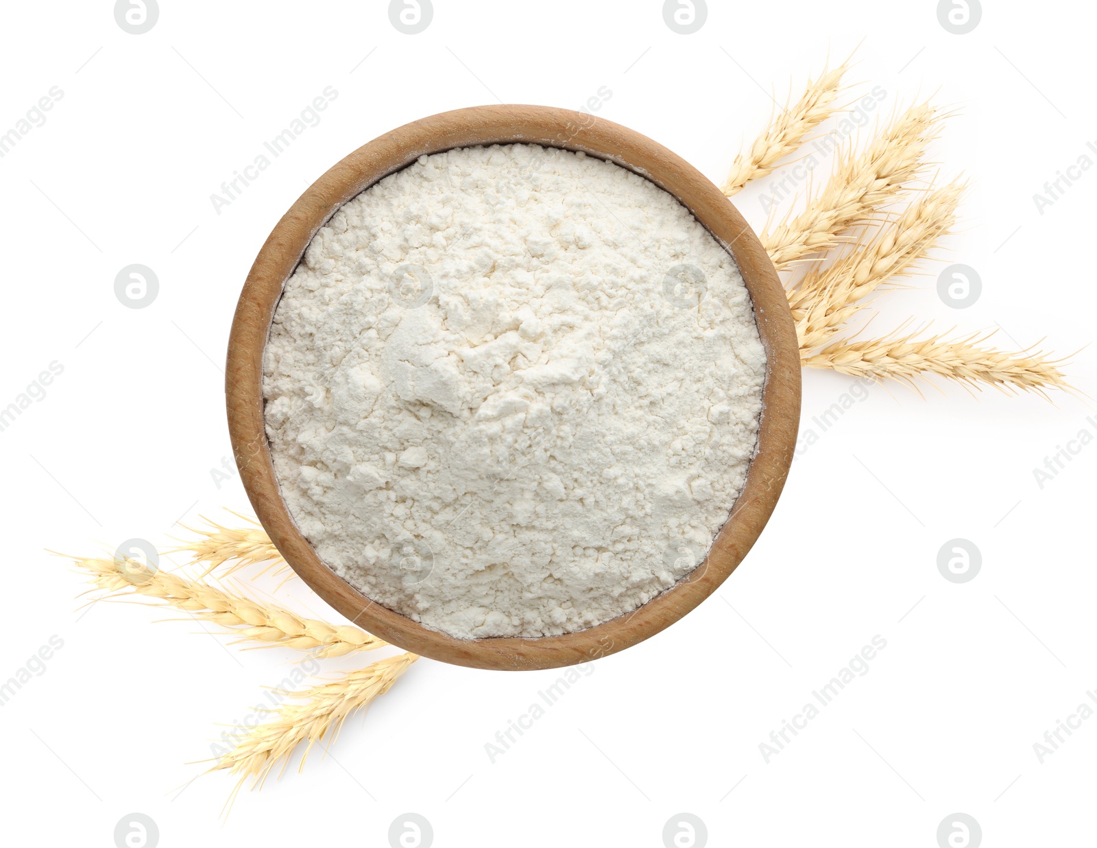 Image of Wheat flour in bowl and spikelets on white background, top view