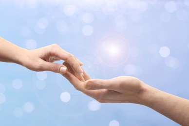 Image of Man and woman holding hands against seascape, closeup