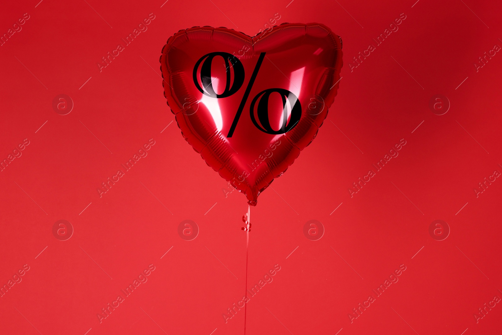 Heart-shaped balloon with percent sign against red background. Hot sale, special offer Image of Heart-shaped balloon with percent sign against red background. Hot sale, special offer
