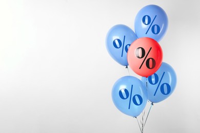 Image of Balloons with percent signs against light background. Hot sale, special offer