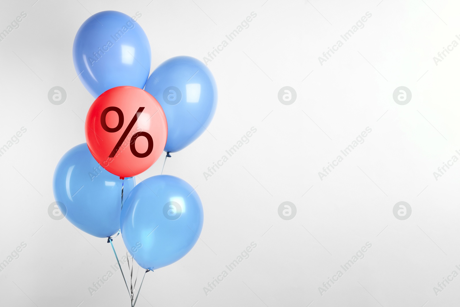 Red balloon with percent sign among light blue ones against light background. Hot sale, special offer Image of Red balloon with percent sign among light blue ones against light background. Hot sale, special offer