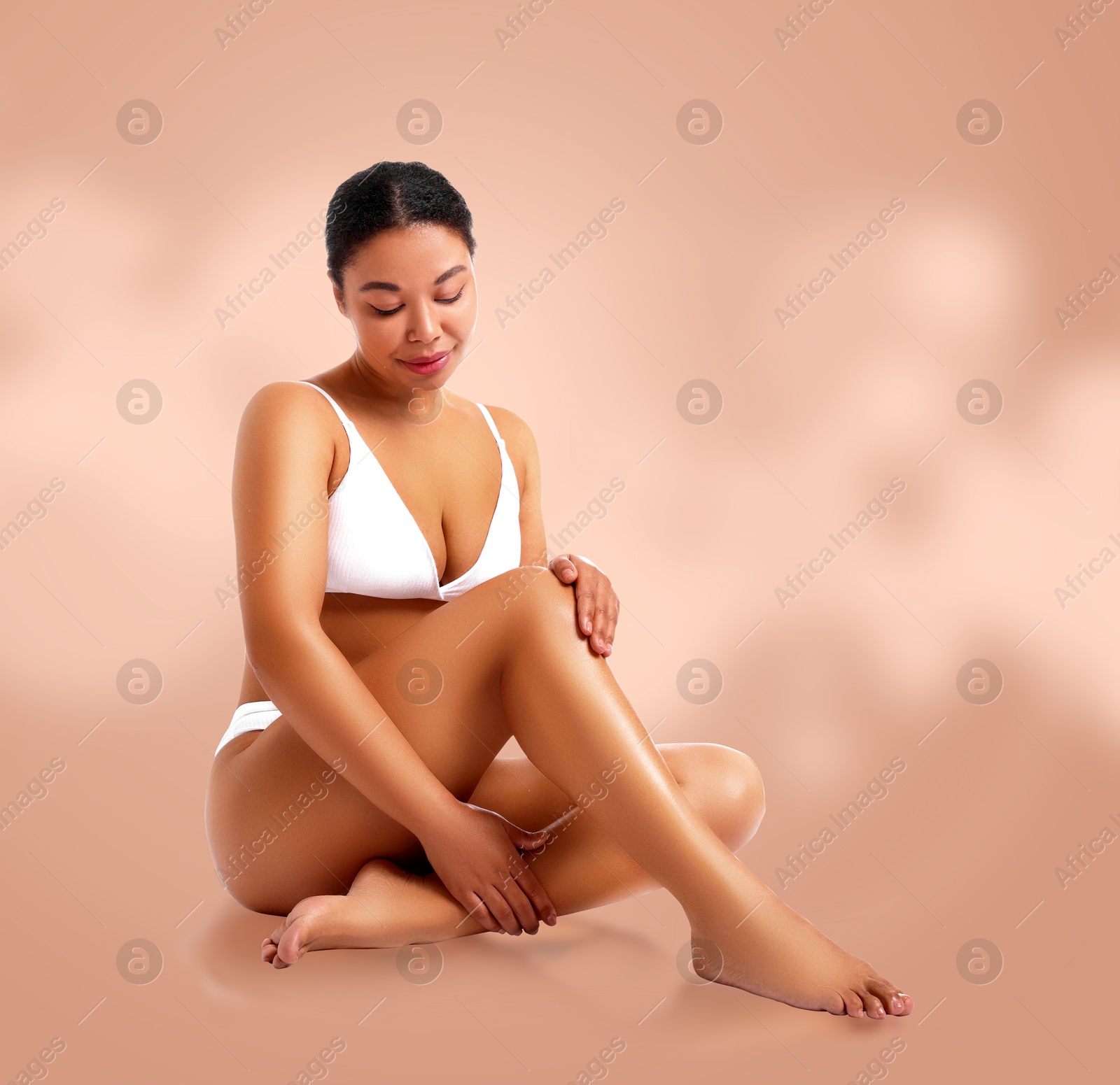 Image of Epilation. Woman showing smooth skin after hair removal against dark beige background
