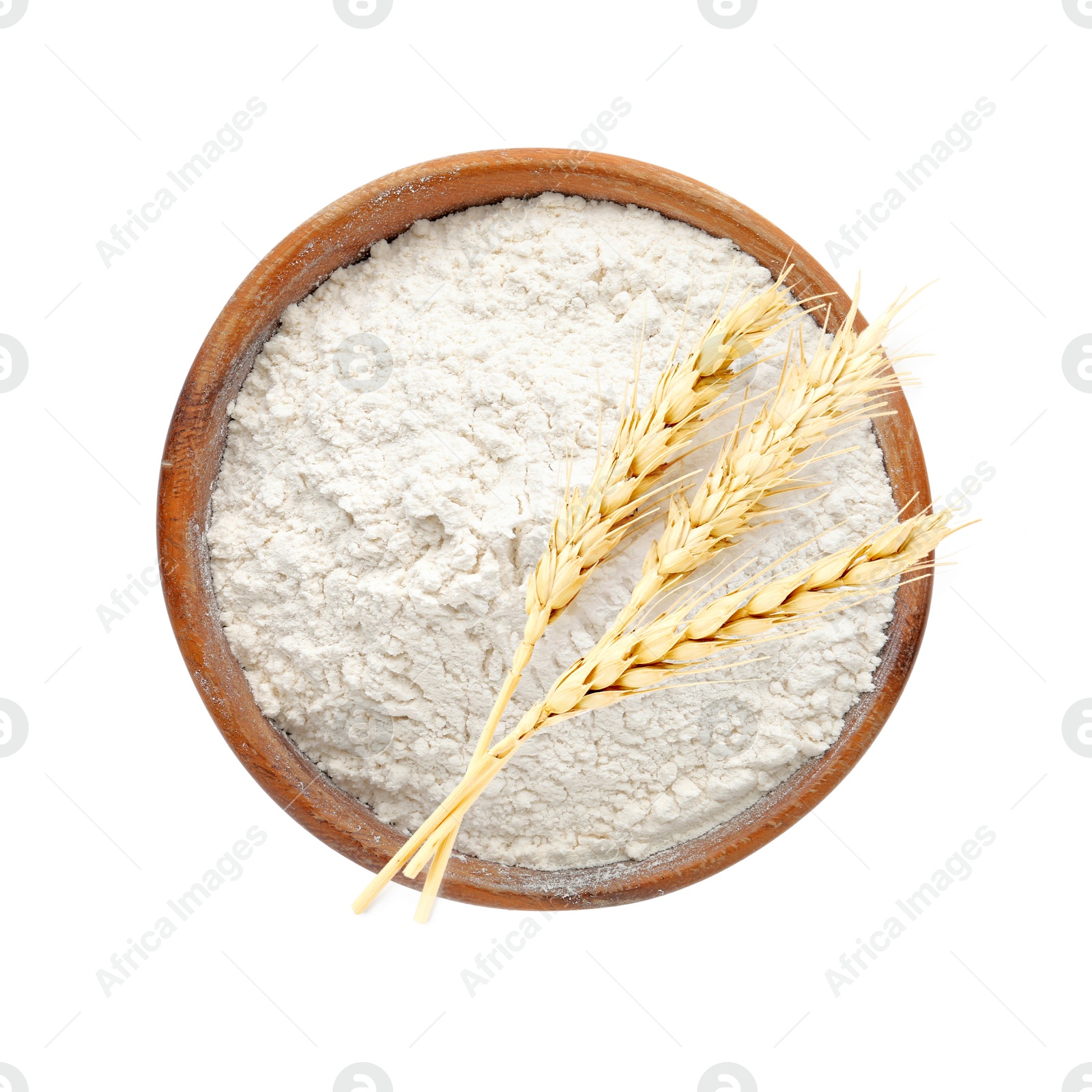 Image of Wheat flour in bowl and spikelets on white background, top view