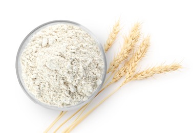 Image of Wheat flour in bowl and spikelets on white background, top view