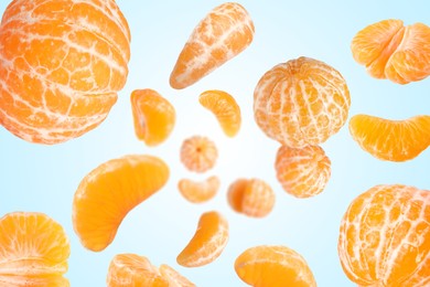 Image of Sweet tangerines whirling in air against light blue gradient background