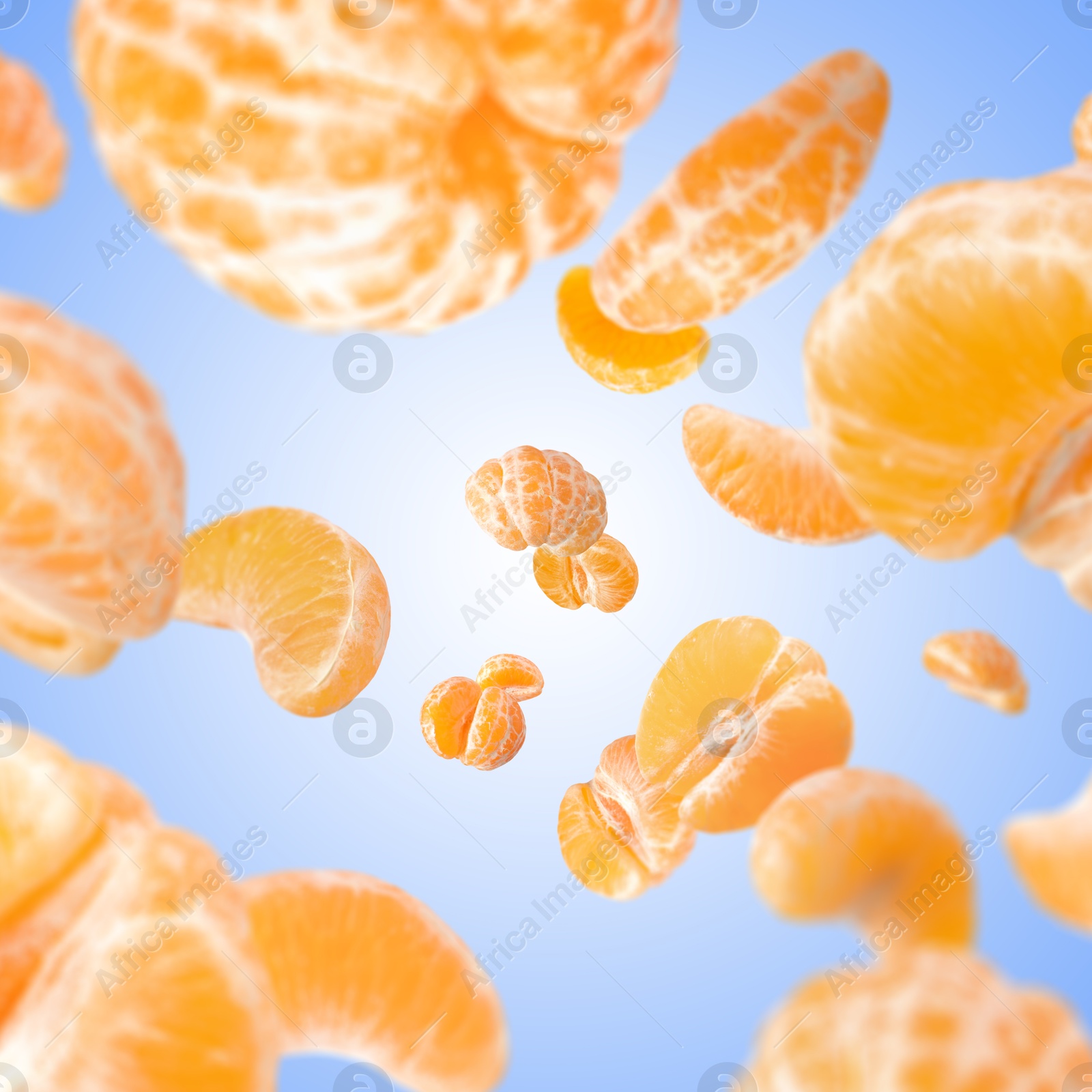 Image of Sweet tangerines whirling in air against blue gradient background