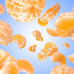 Image of Sweet tangerines whirling in air against blue gradient background