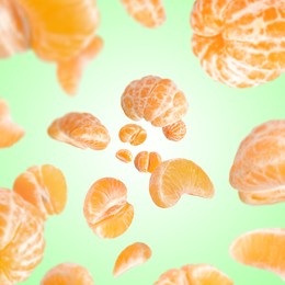 Image of Sweet tangerines whirling in air against aquamarine gradient background
