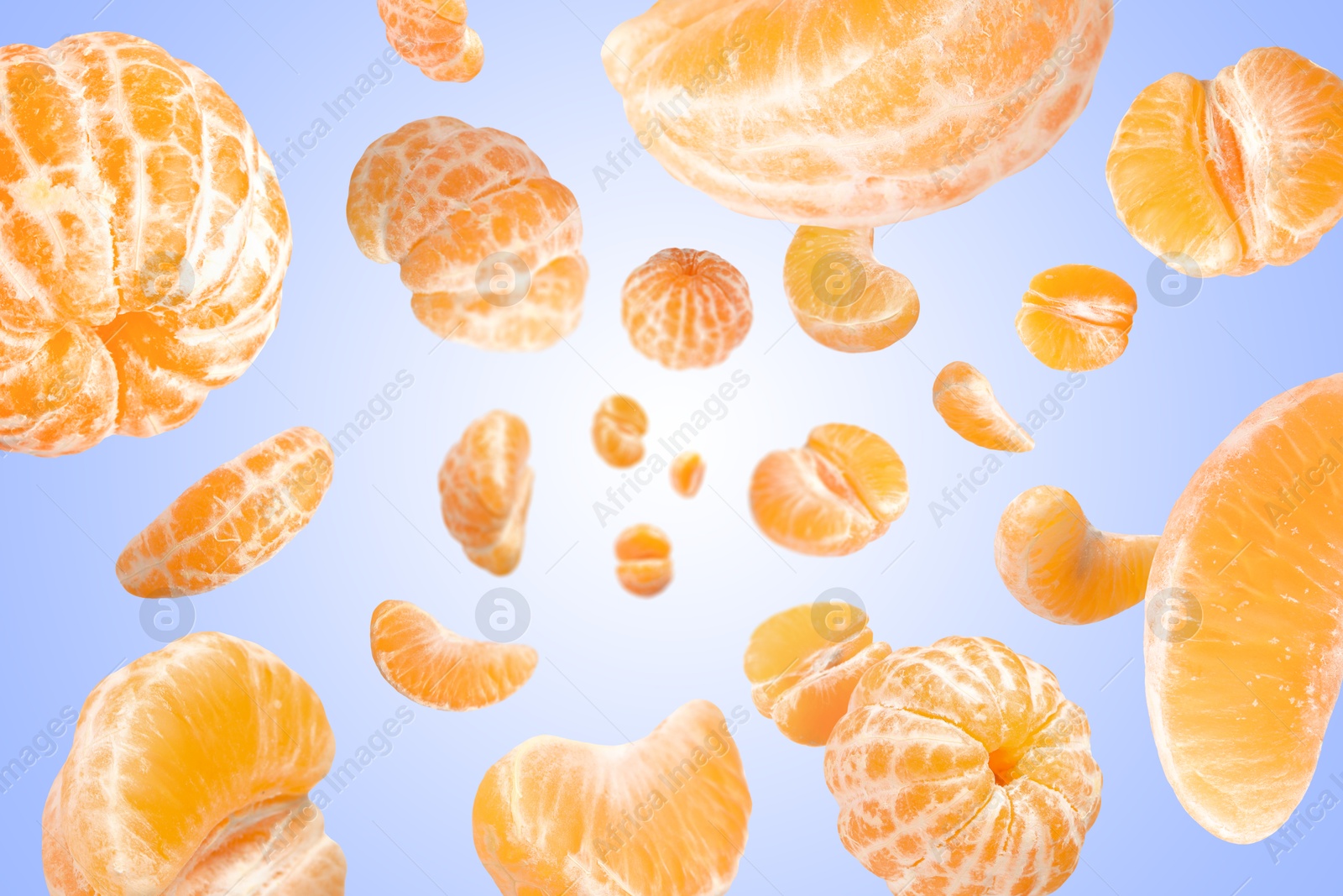 Image of Sweet tangerines whirling in air against blue gradient background