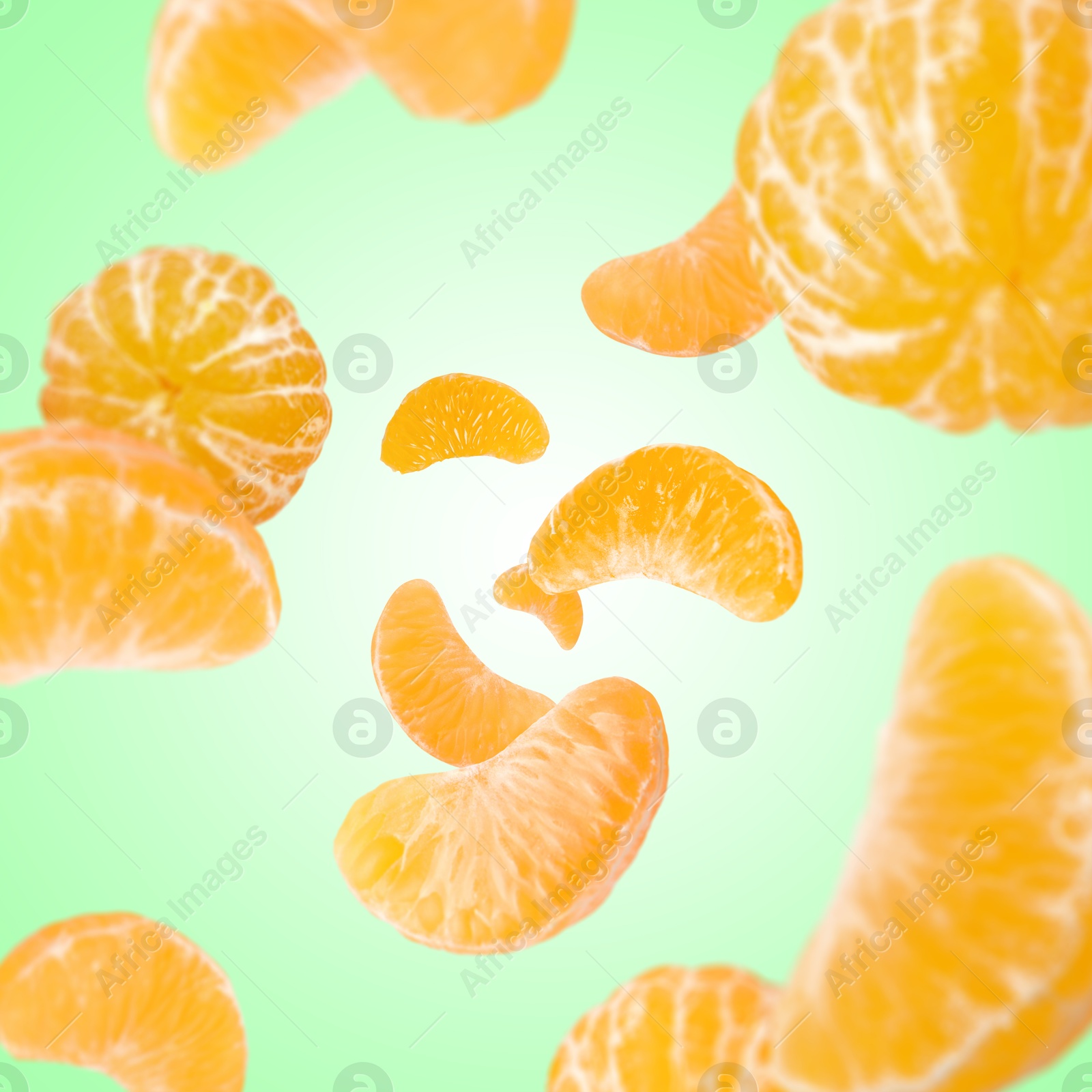 Image of Sweet tangerines whirling in air against aquamarine gradient background