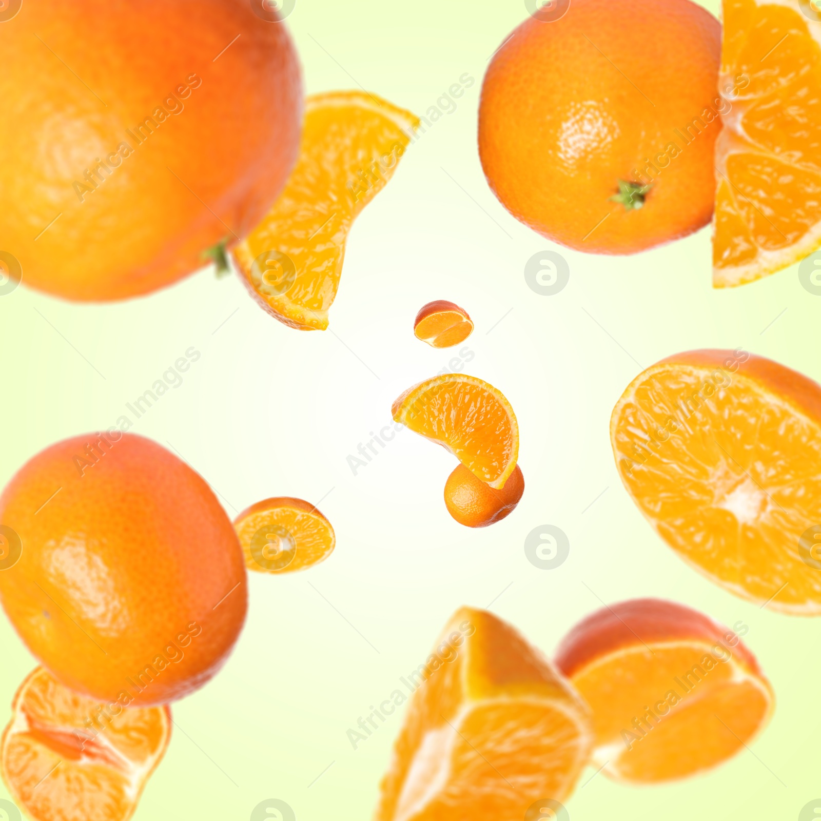 Image of Sweet tangerines whirling in air against beige gradient background