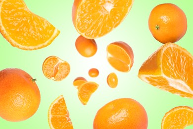 Image of Sweet tangerines whirling in air against green gradient background