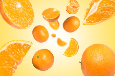Image of Sweet tangerines whirling in air against pale orange background