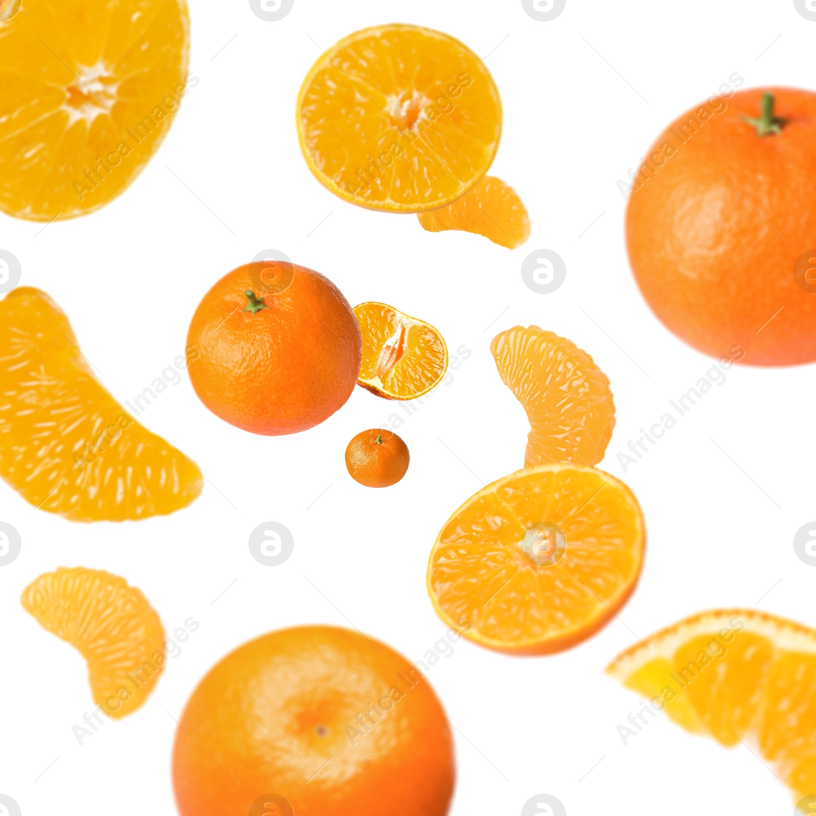 Image of Sweet tangerines whirling in air against white background
