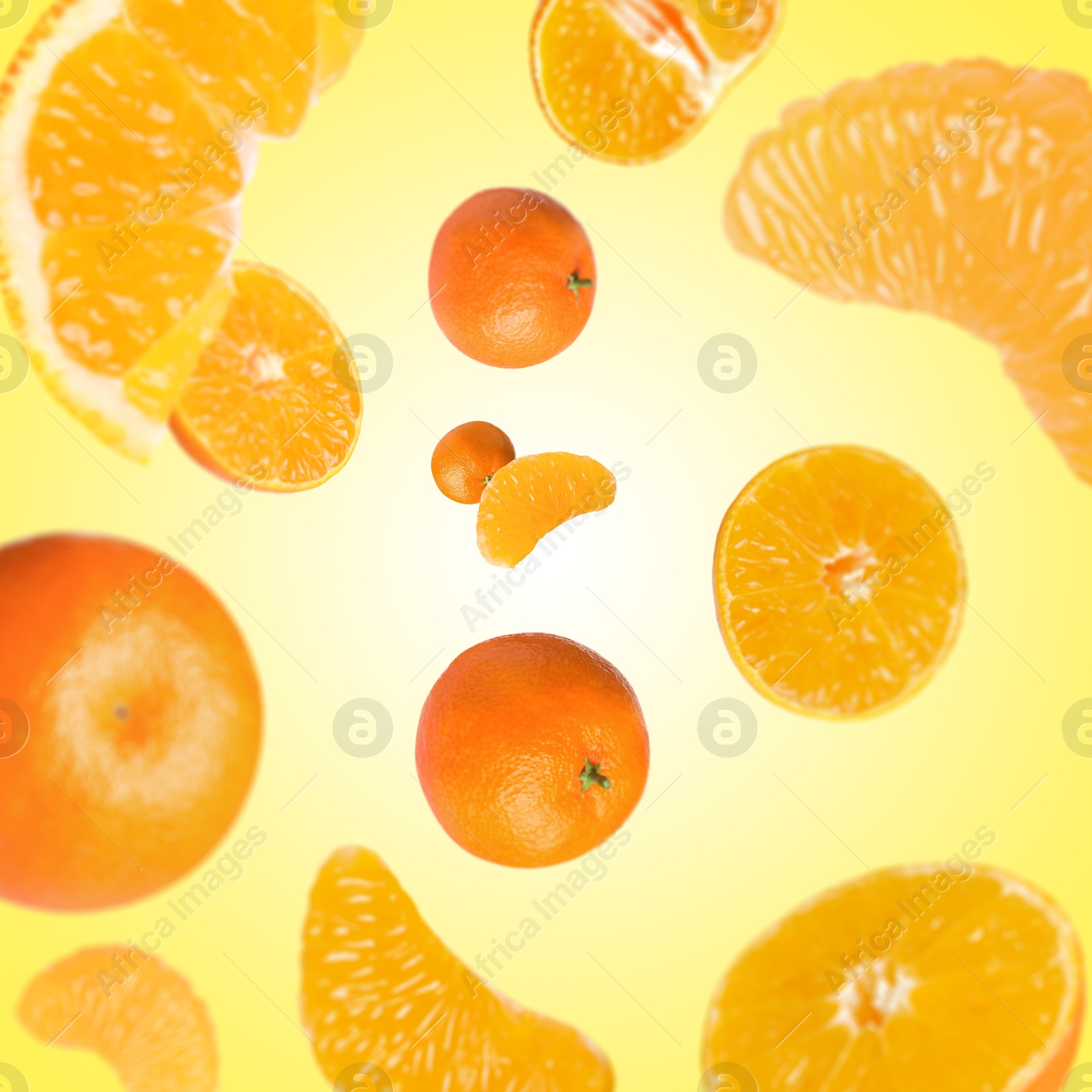 Image of Sweet tangerines whirling in air against yellow background