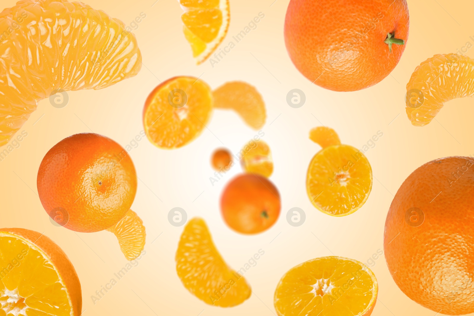 Image of Sweet tangerines whirling in air against pale orange background