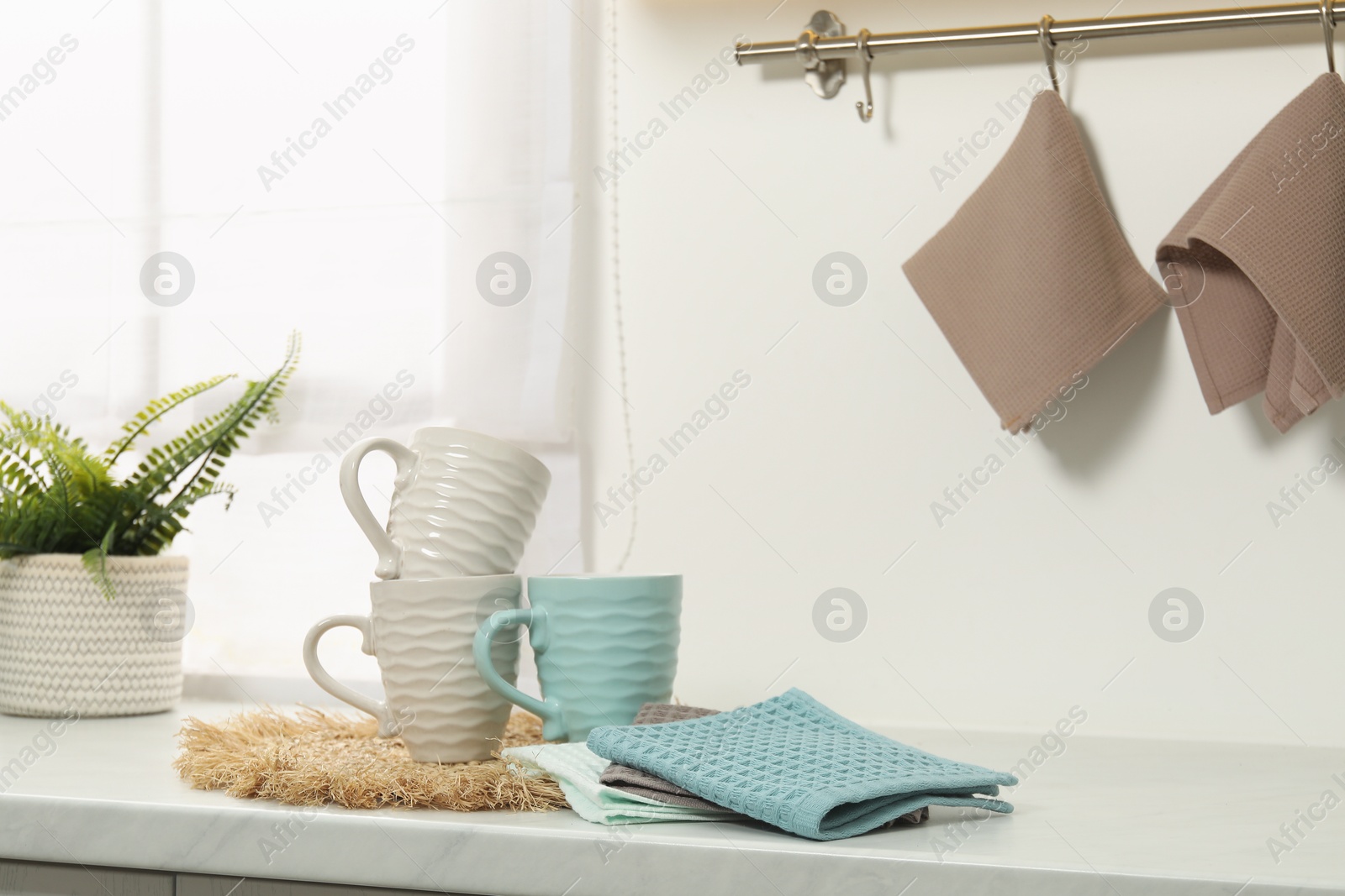 Photo of Clean waffle towels and cups on counter in kitchen