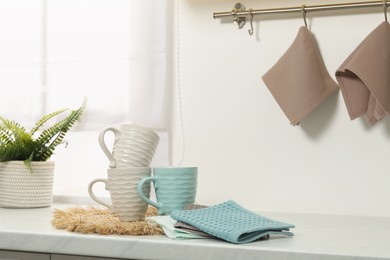 Photo of Clean waffle towels and cups on counter in kitchen