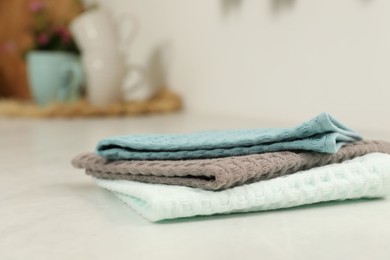 Photo of Clean waffle towels on white table, closeup