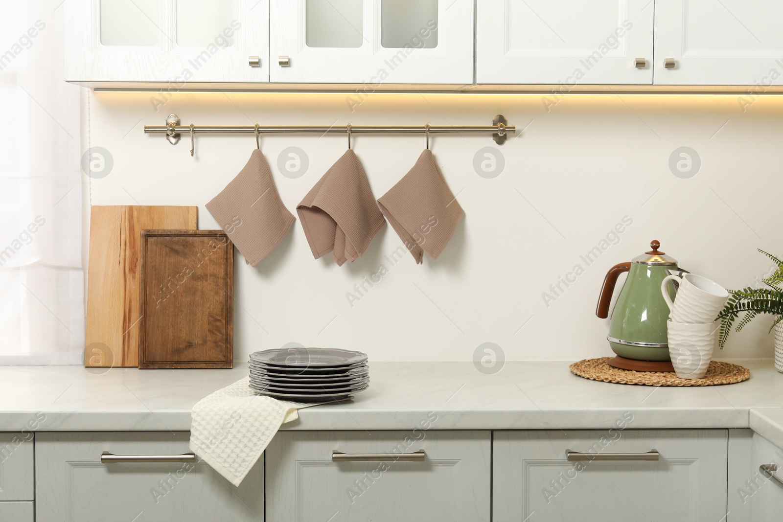 Photo of Clean waffle towels and plates on counter in kitchen