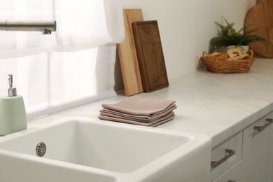 Photo of Clean waffle towels on counter near sink in kitchen