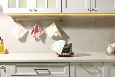 Photo of Clean waffle towels hanging on hook rack above counter in kitchen