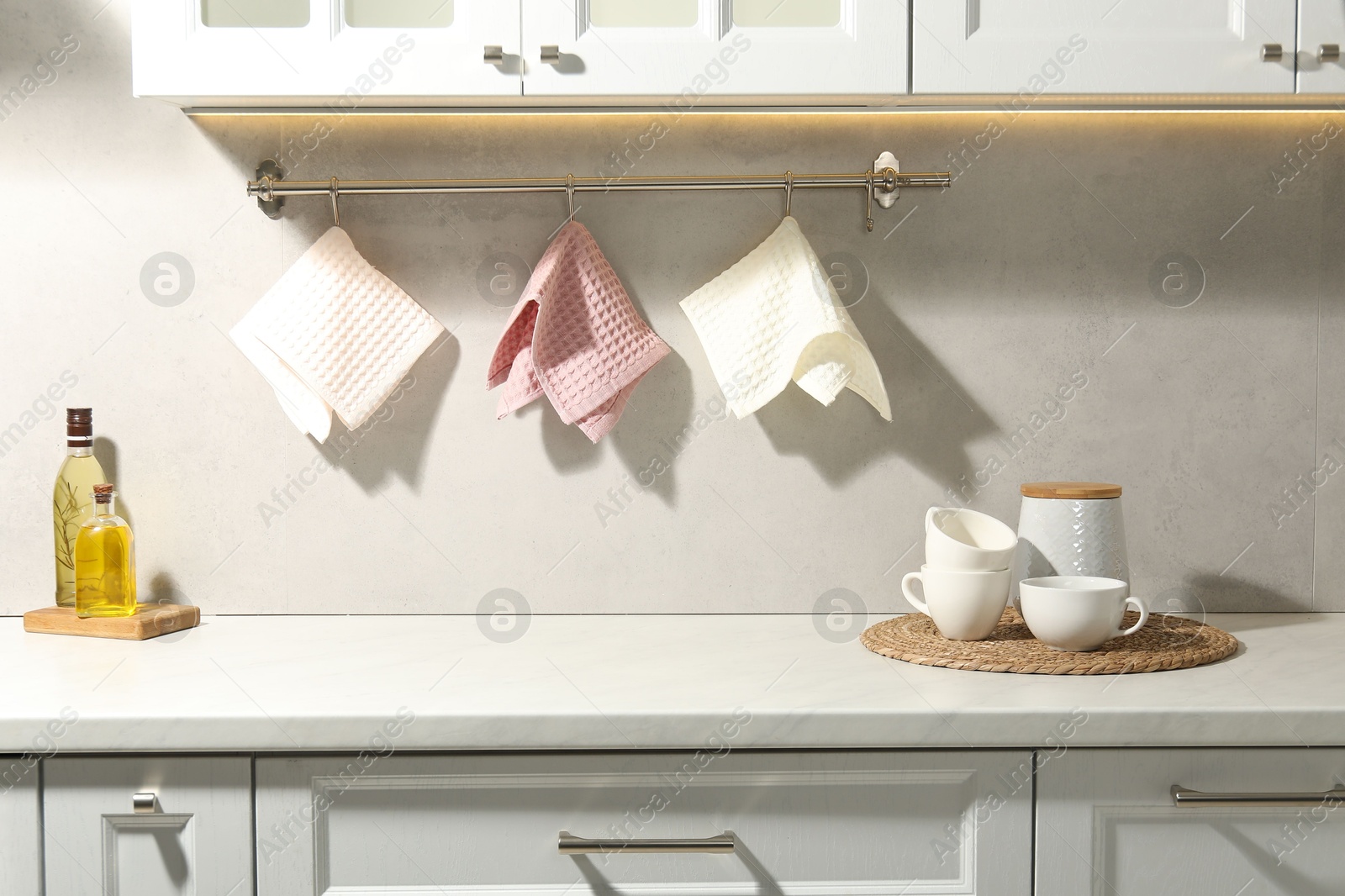 Photo of Clean waffle towels hanging on hook rack above counter in kitchen