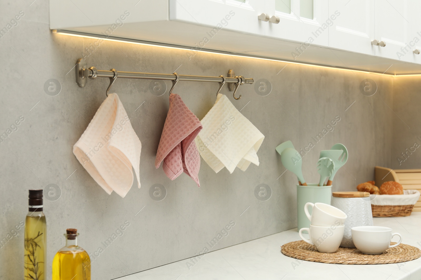 Photo of Clean waffle towels hanging on hook rack above counter in kitchen