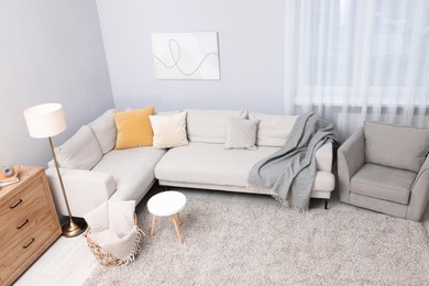 Photo of Contemporary furniture, lamp and decor in stylish living room, above view. Interior design