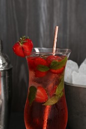 Photo of Refreshing strawberry cocktail in glass on dark background, closeup