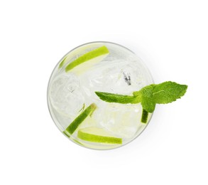 Photo of Tasty cocktail with lime slices and mint in glass isolated on white, top view