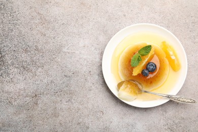 Photo of Tasty panna cotta with orange, blueberries and mint on light grey table, top view. Space for text