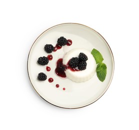 Photo of Tasty panna cotta with blackberries, mint and sauce isolated on white, top view