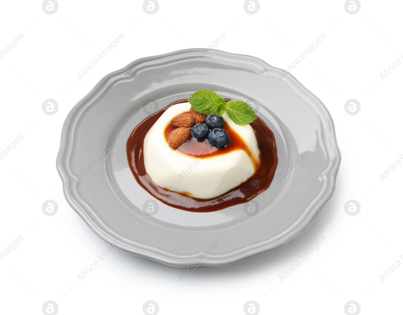 Photo of Tasty panna cotta with blueberries, almonds and sauce isolated on white