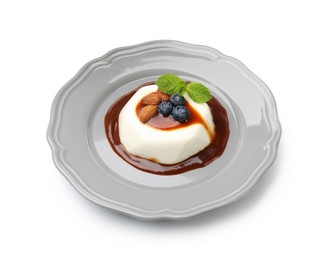 Photo of Tasty panna cotta with blueberries, almonds and sauce isolated on white