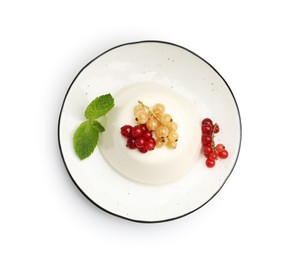 Photo of Tasty panna cotta with currants and mint isolated on white, top view