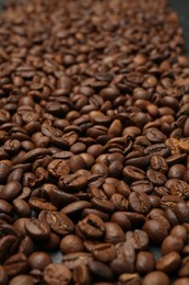 Photo of Aromatic coffee beans as background, closeup view