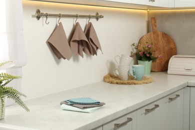 Photo of Clean waffle towels and cups on counter in kitchen