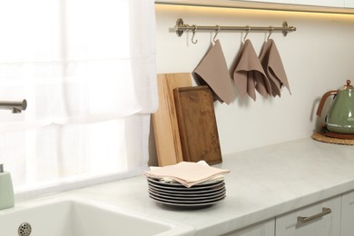 Photo of Clean waffle towels and plates on counter in kitchen