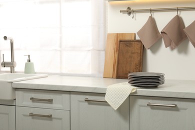 Photo of Clean waffle towels and plates on counter in kitchen