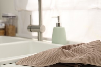 Photo of Clean waffle towel on counter near sink, closeup
