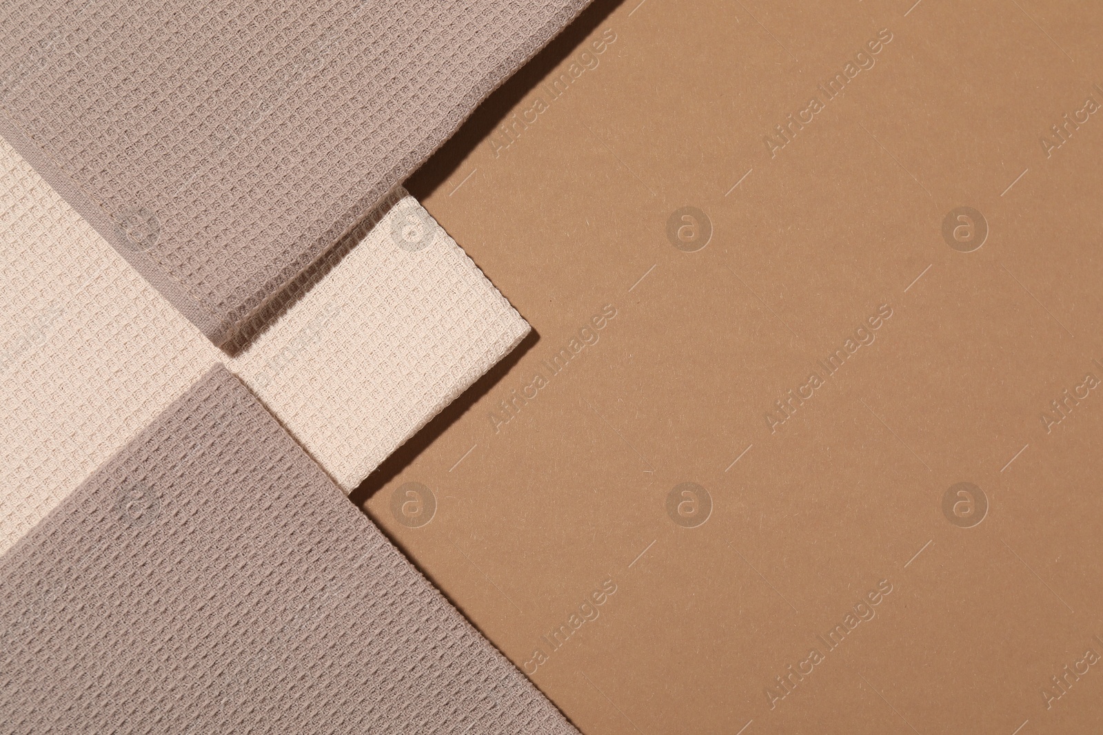 Photo of Folded waffle towels on light brown background, flat lay. Space for text
