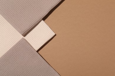 Photo of Folded waffle towels on light brown background, flat lay. Space for text