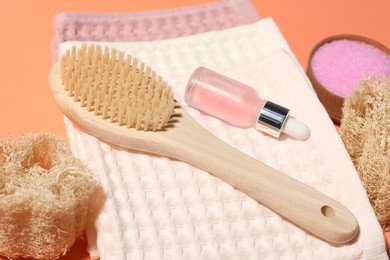 Photo of Clean waffle towels and spa products on coral background, closeup
