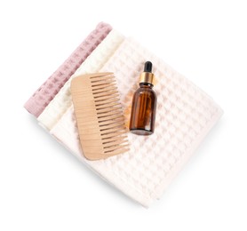Photo of Clean waffle towels, dropper and comb isolated on white, top view