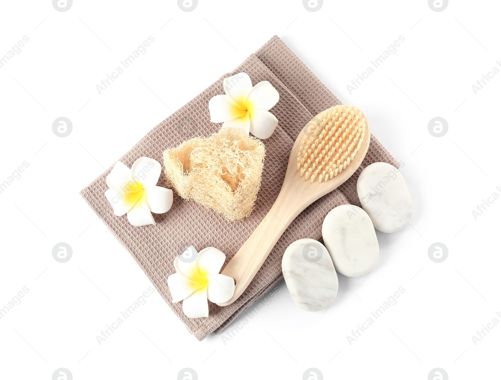 Photo of Clean waffle towels, plumeria flowers and spa products isolated on white, top view