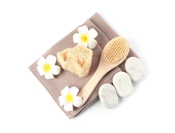 Photo of Clean waffle towels, plumeria flowers and spa products isolated on white, top view
