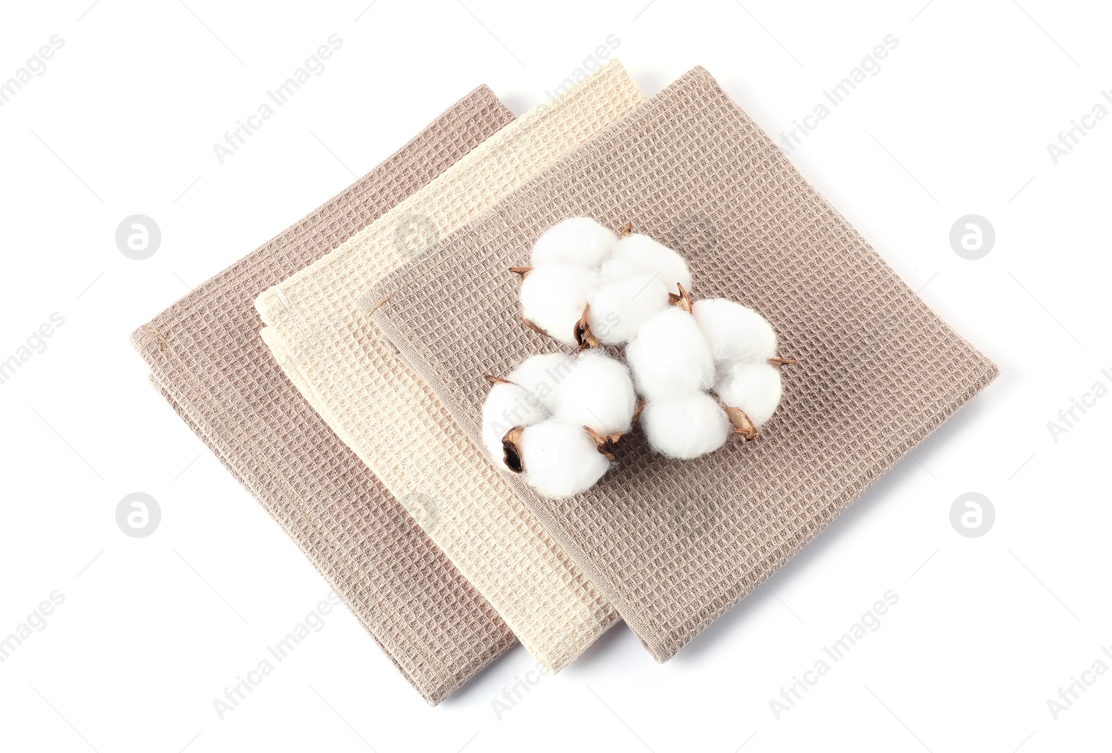 Photo of Clean waffle towels and cotton flowers isolated on white, above view
